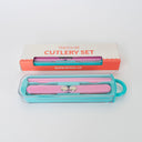 Pink cutlery set with teal case on a white background