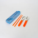 Set of orange cutlery with blue case on a white background