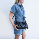 Cleo Leather handbag Butter Leather Soft Black with Spixal logo Modelled on women in denim dress