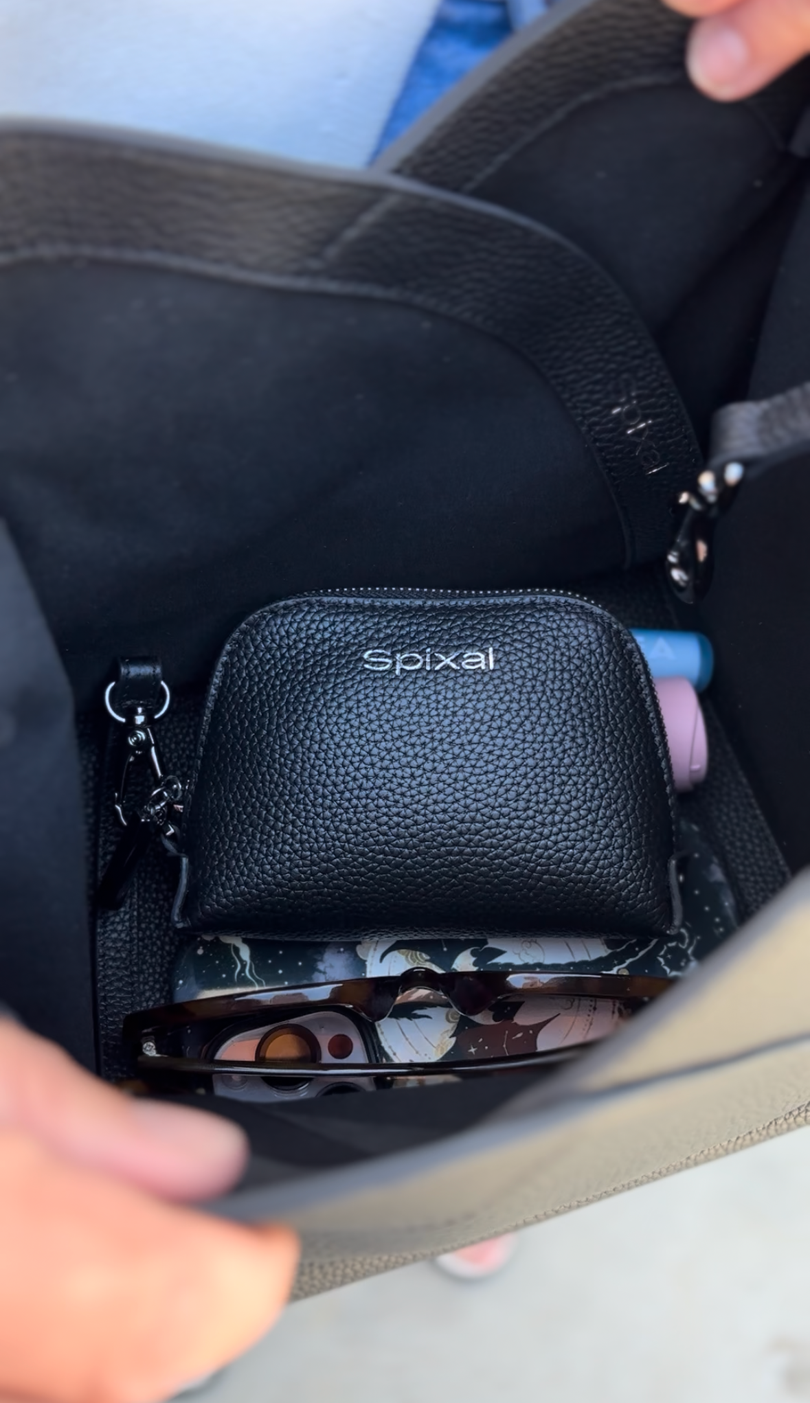 Black soft leather handbag cinched closed by drawstring