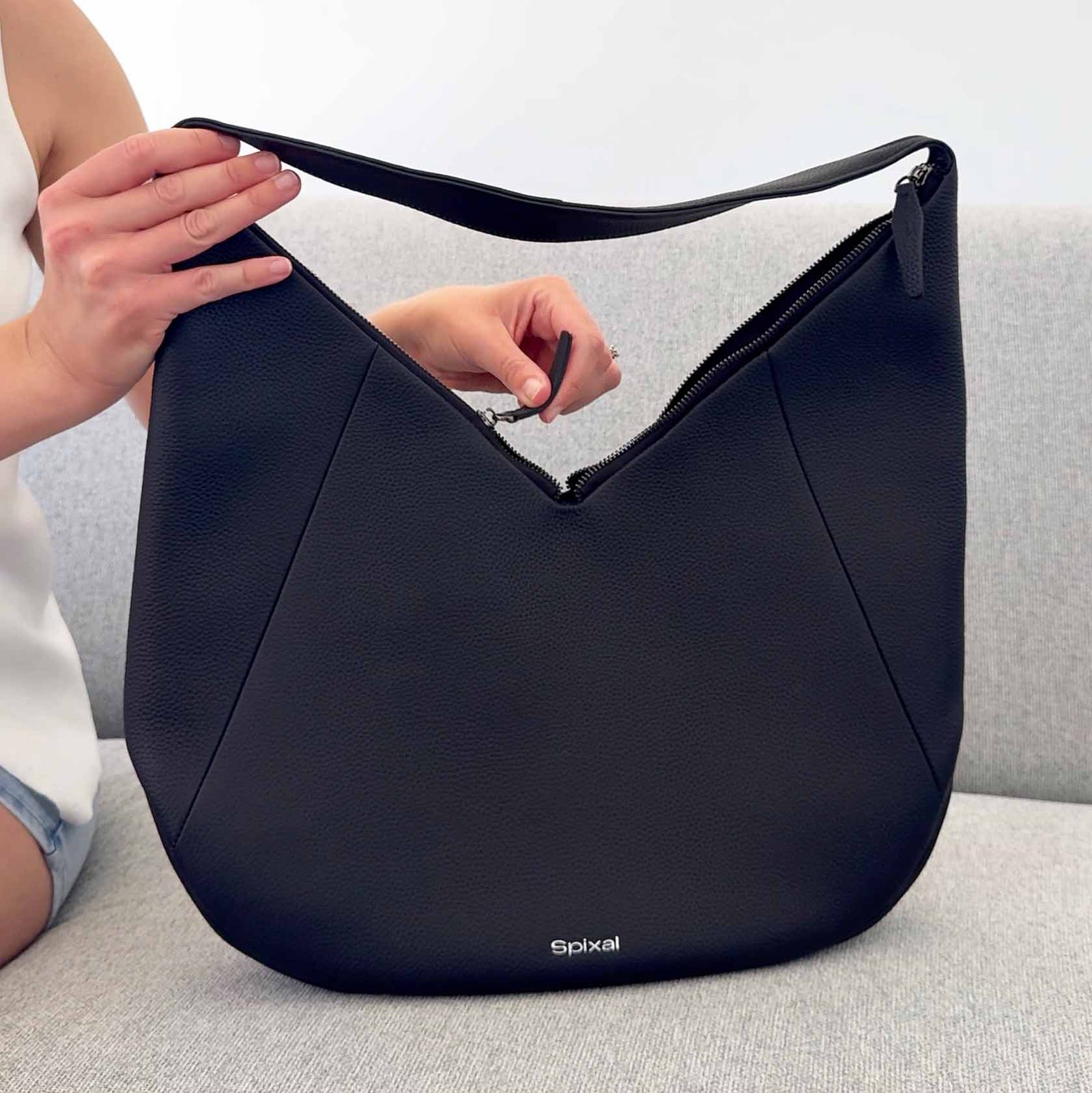 Shoulder carry handbag with dual zip access