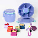 A set of Spixal lunch containers and accessories on a clean white background, including a purple insulated food jar with teal trim, a purple spinner lid, smaller colourful containers with food samples, a purple magnetic hat clip.