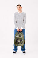 Large green camouflage camo Axis school bag carried by teen school boy | Spixal