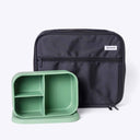 Black lunch bag and green bento box container on a white background