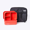 Red silicone lunch container with compartments and a black carrying case on a white background