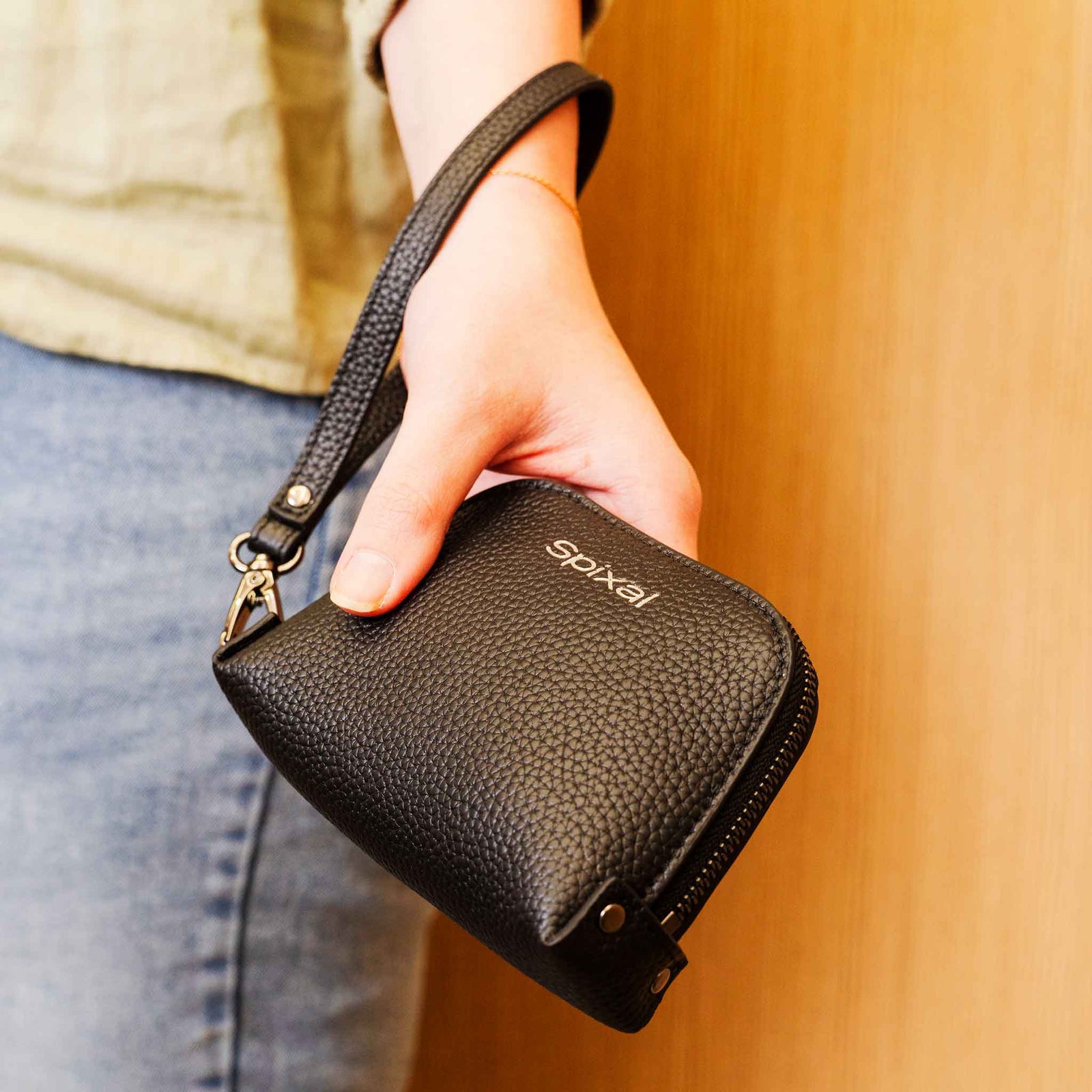 Black soft leather handbag cinched closed by drawstring