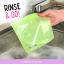 A hand holds a green Spixal silicone snack and sandwich bag under running water in a sink, with the text 'RINSE & GO!' and 'Clean in seconds.' on the image.